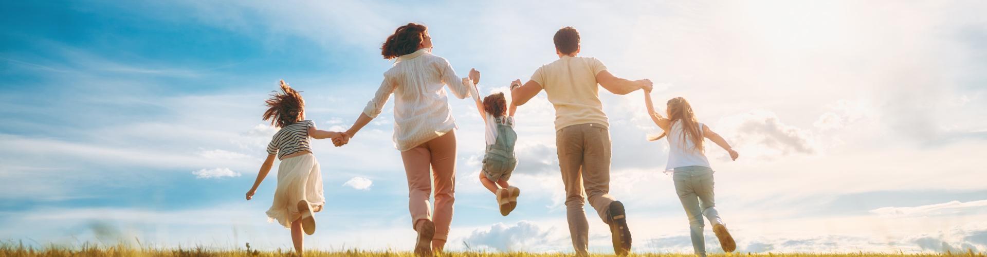 des enfants et leurs parents courent dans un champ